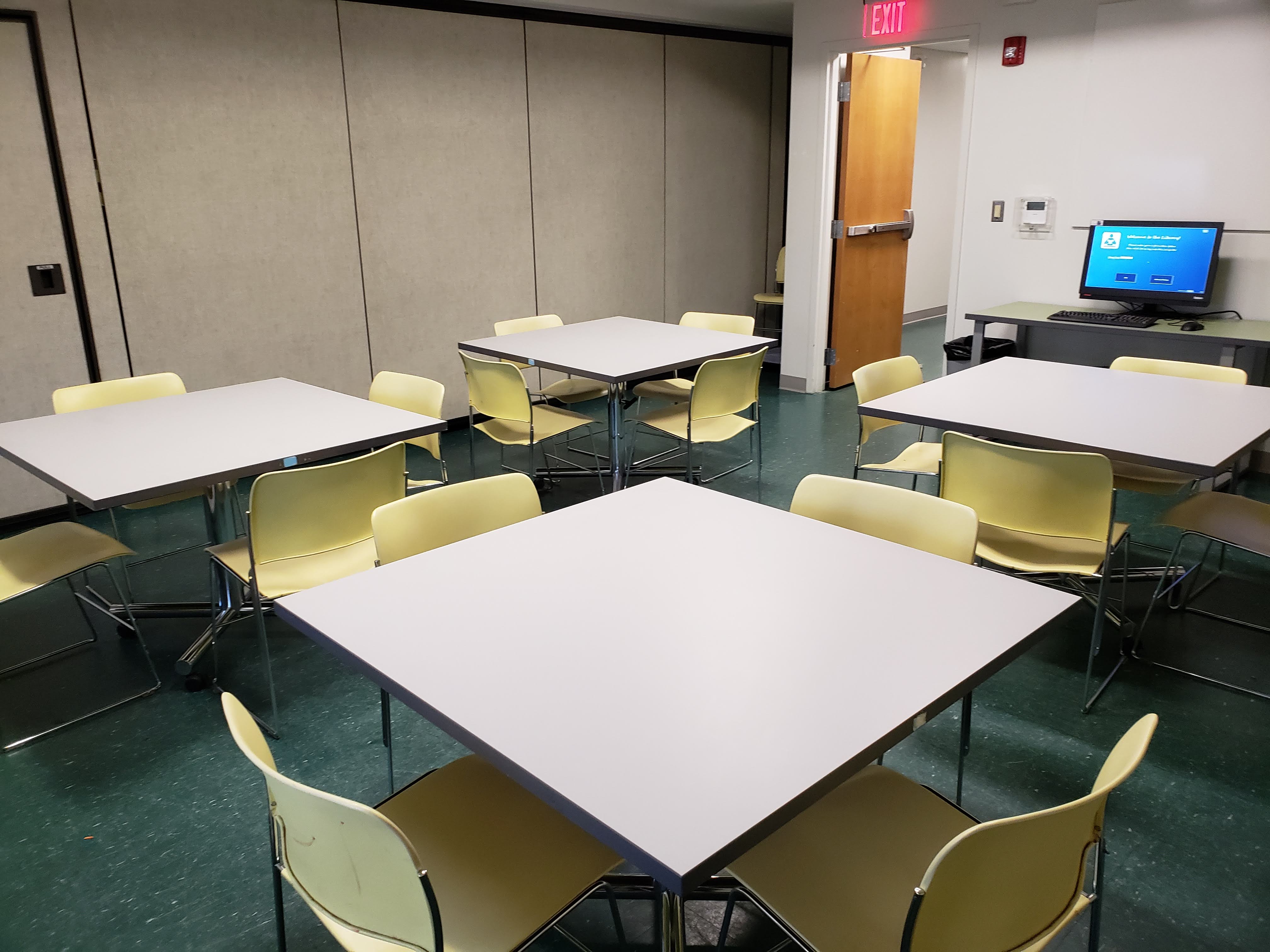 Wilkins Room with four square tables and four chairs at each table
