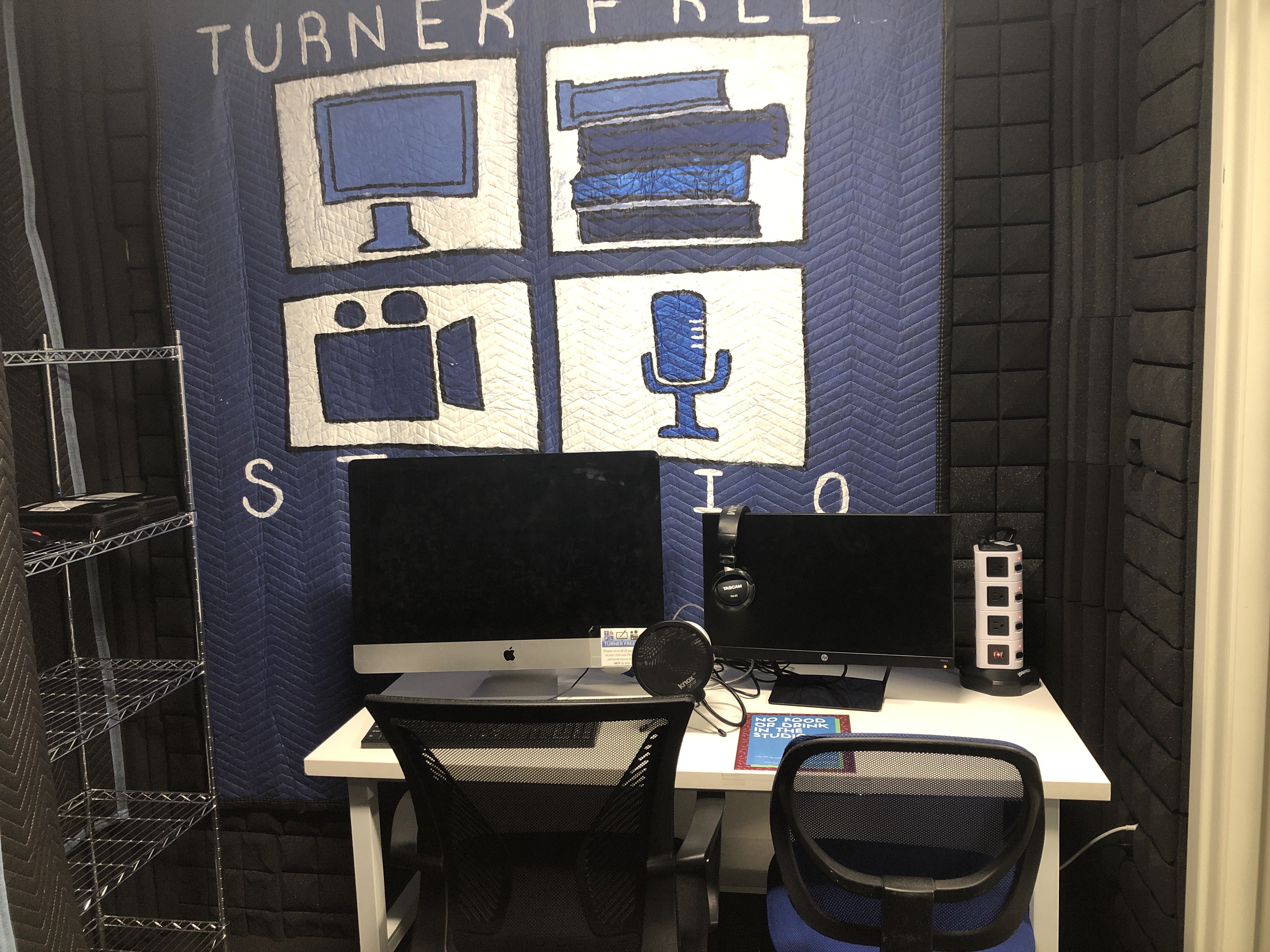 Turner Studio desk with computers and logo